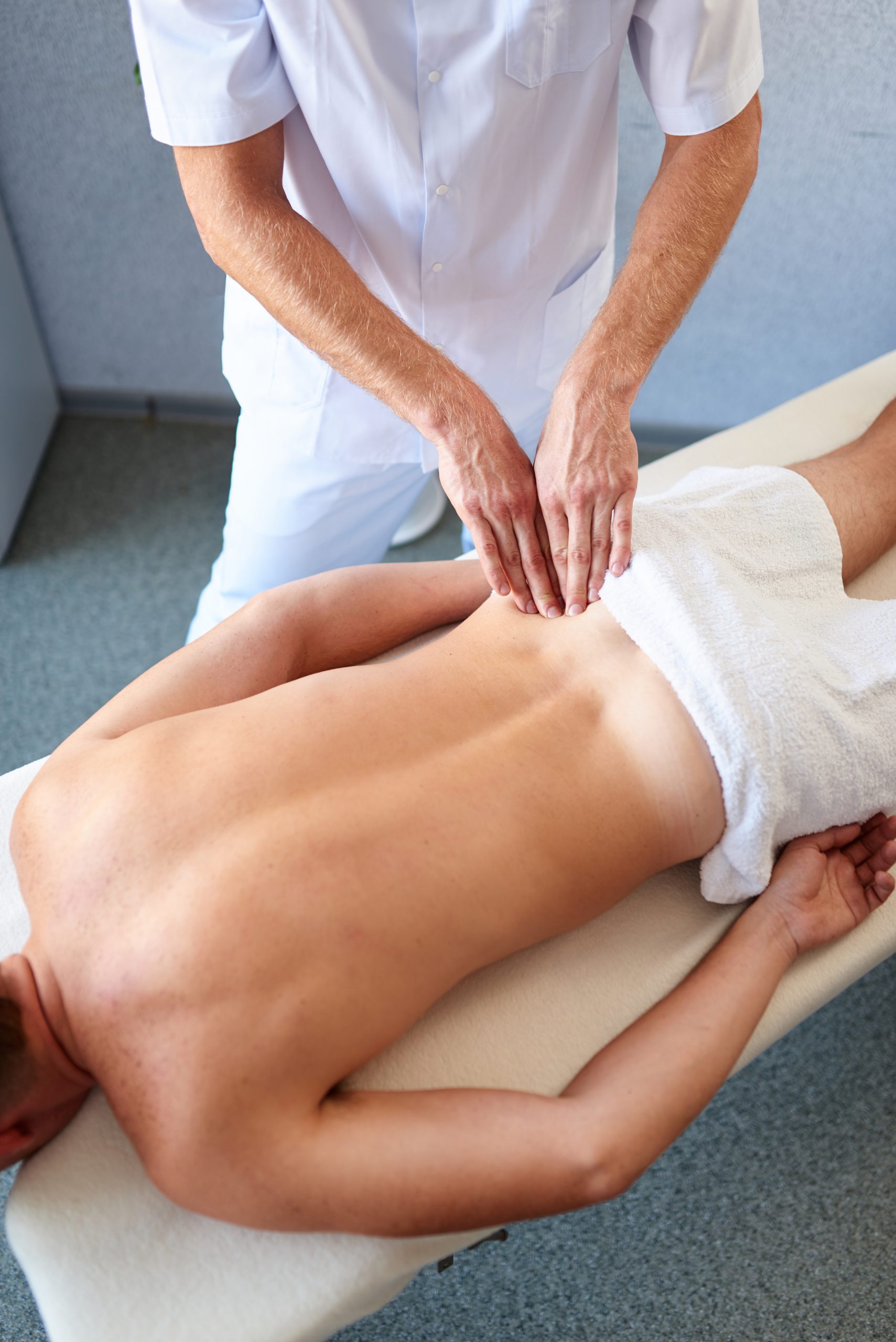 Professional physiotherapy in a cabinet, back massage